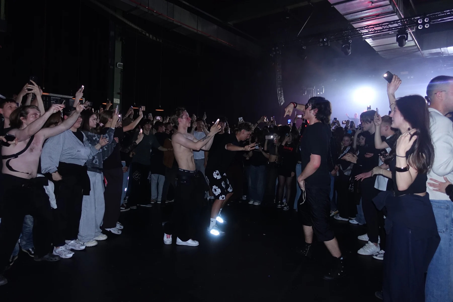 Fans facing each other in the concert crowd